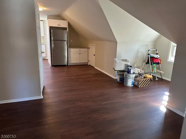 a room with wooden floor and cabinets