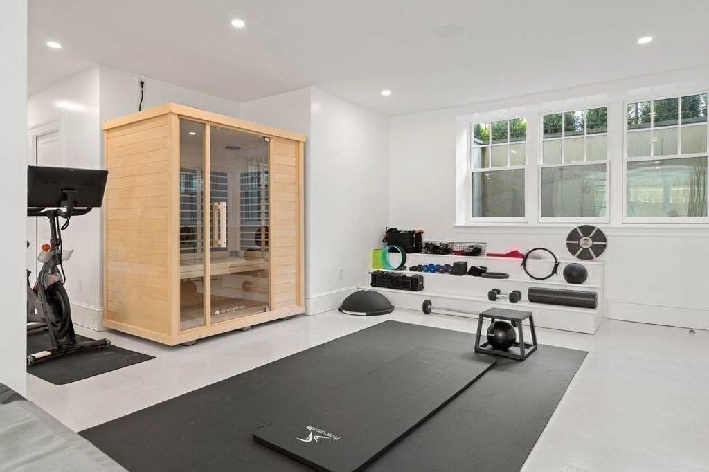 19 Crafts Road Brookline, MA 02467 - Photo 23 of 24 a living room with furniture gym equipment and a large window