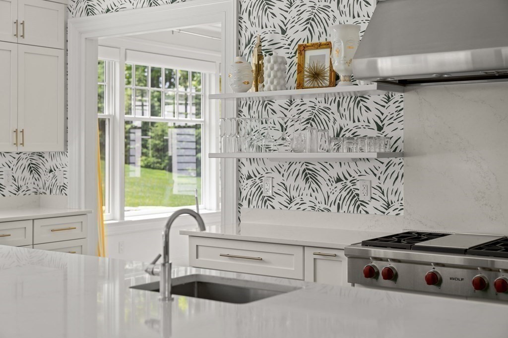 19 Crafts Road Brookline, MA 02467 - Photo 9 of 24 a kitchen with a stove and a white cabinet