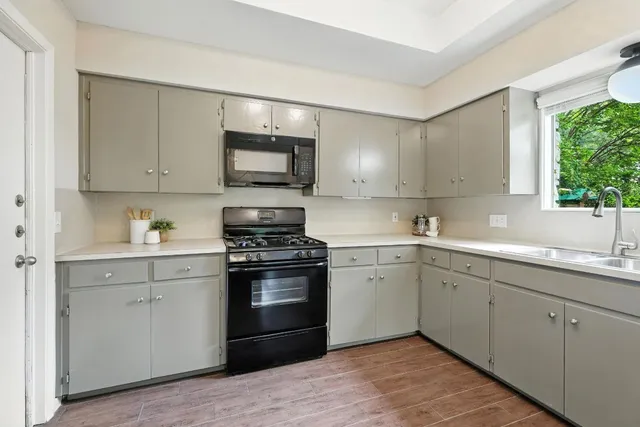 a kitchen with a sink stove and microwave