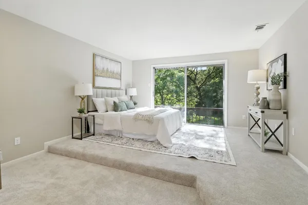 a bedroom with a bed and large window