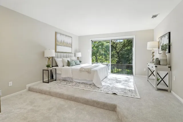 a bedroom with a bed and large window