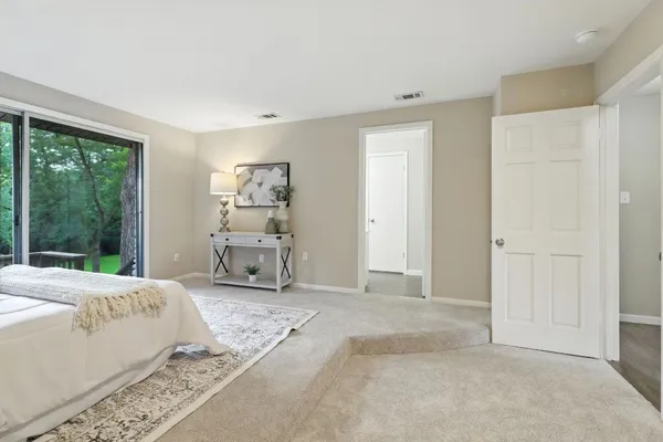 a bedroom with a bed and a large window