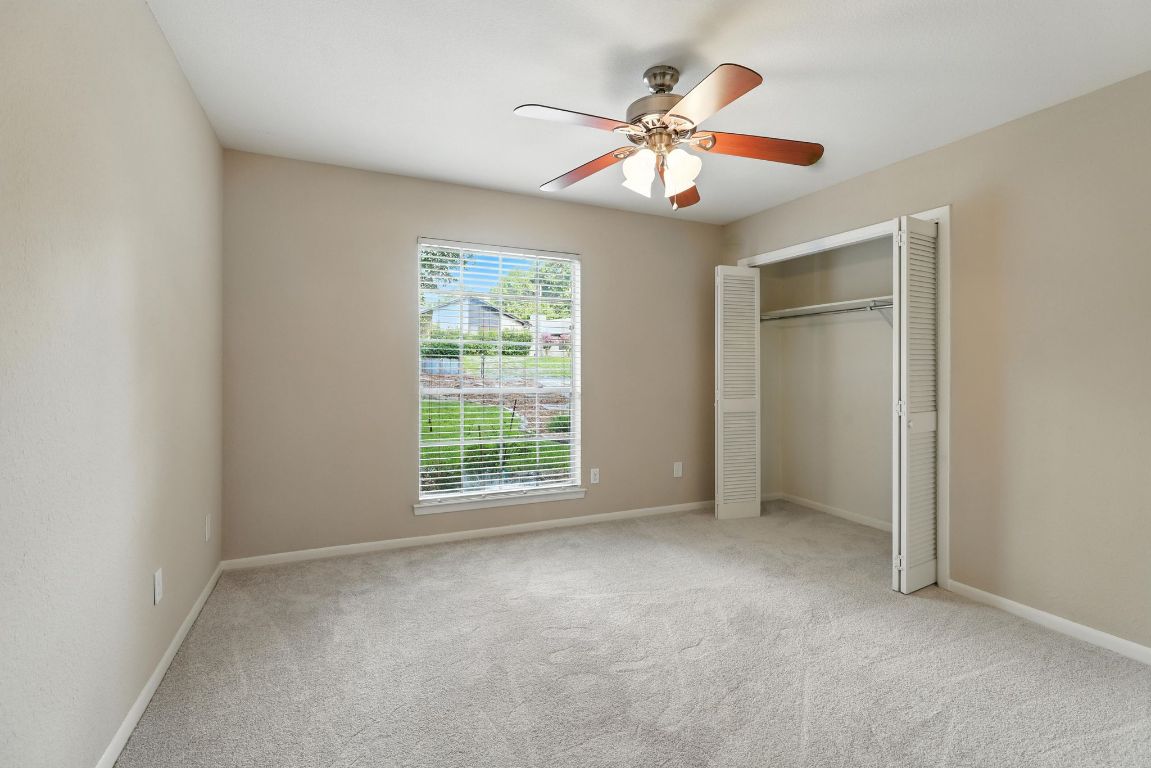 11915 River Oaks Trail Austin, TX 78753 - Photo 15 of 32 an empty room with windows and fan