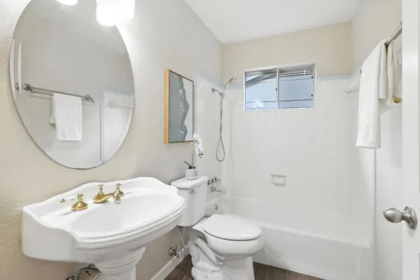 a bathroom with a sink toilet and a mirror