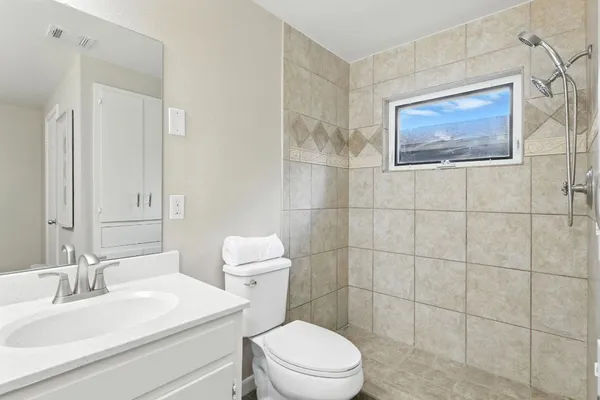 a bathroom with a toilet a sink and mirror