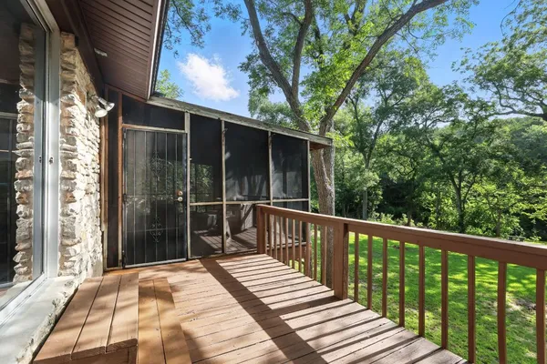 a view of balcony with wooden floor and fence