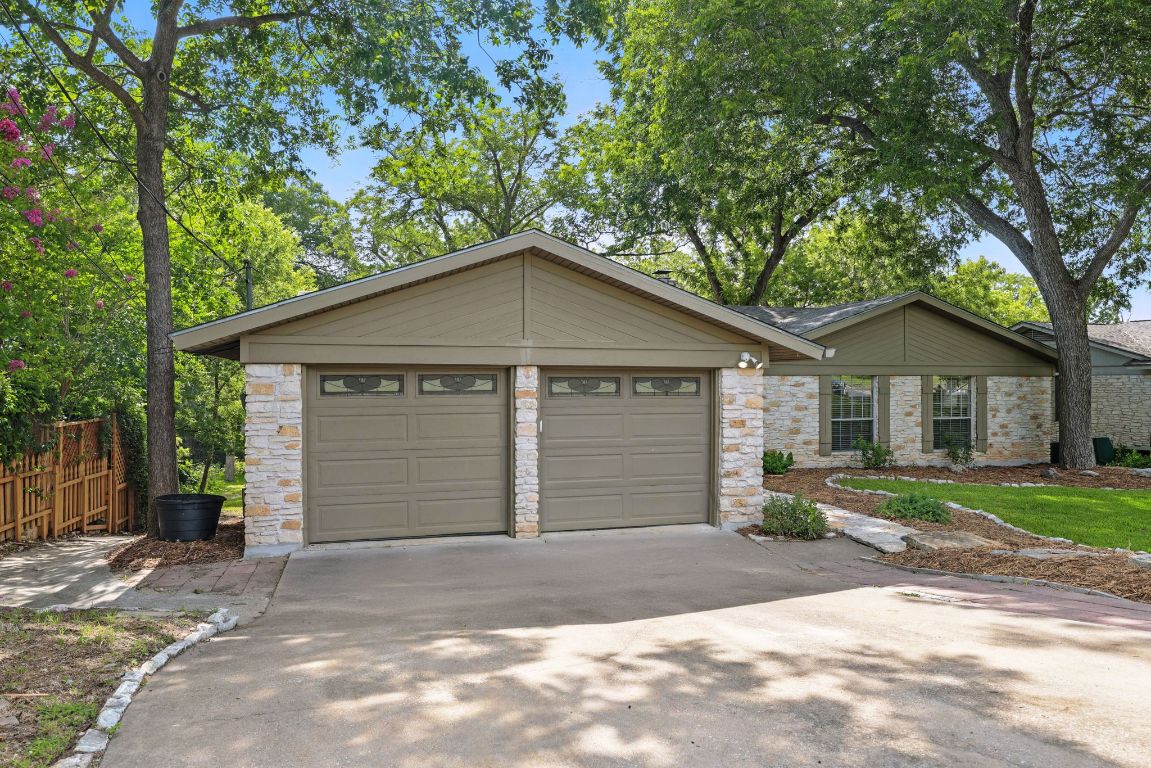 11915 River Oaks Trail Austin, TX 78753 - Photo 3 of 32 a front view of a house with a yard and garage