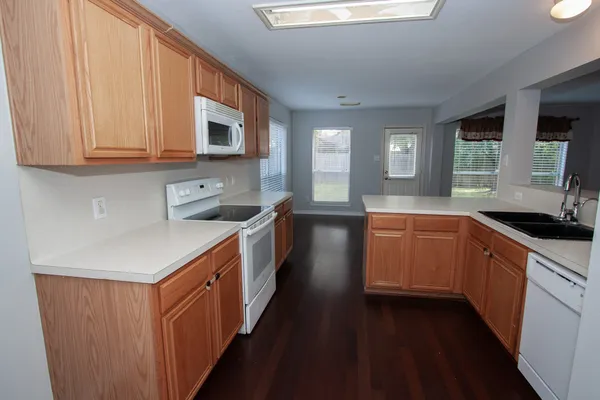 a kitchen with stainless steel appliances granite countertop a sink stove and cabinets
