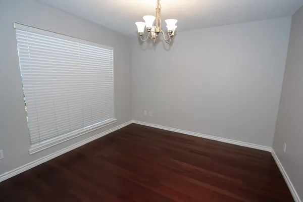 a view of a room with wooden floor and chandelier