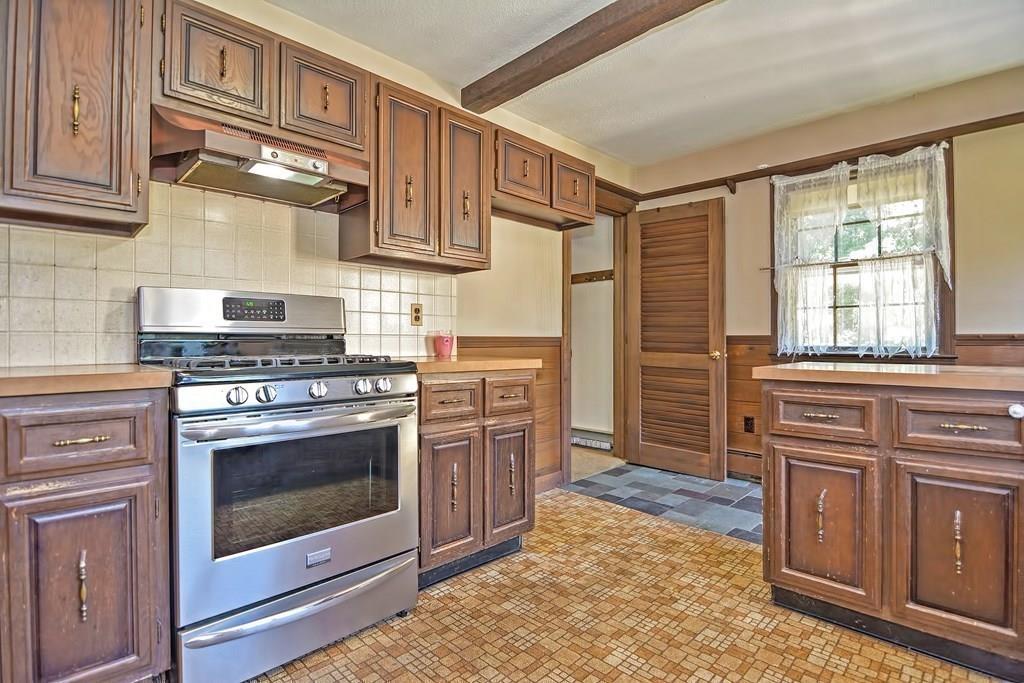 149 West Acton Road Stow, MA 01775 - Photo 11 of 42 a kitchen with stainless steel appliances granite countertop a stove a sink and a refrigerator