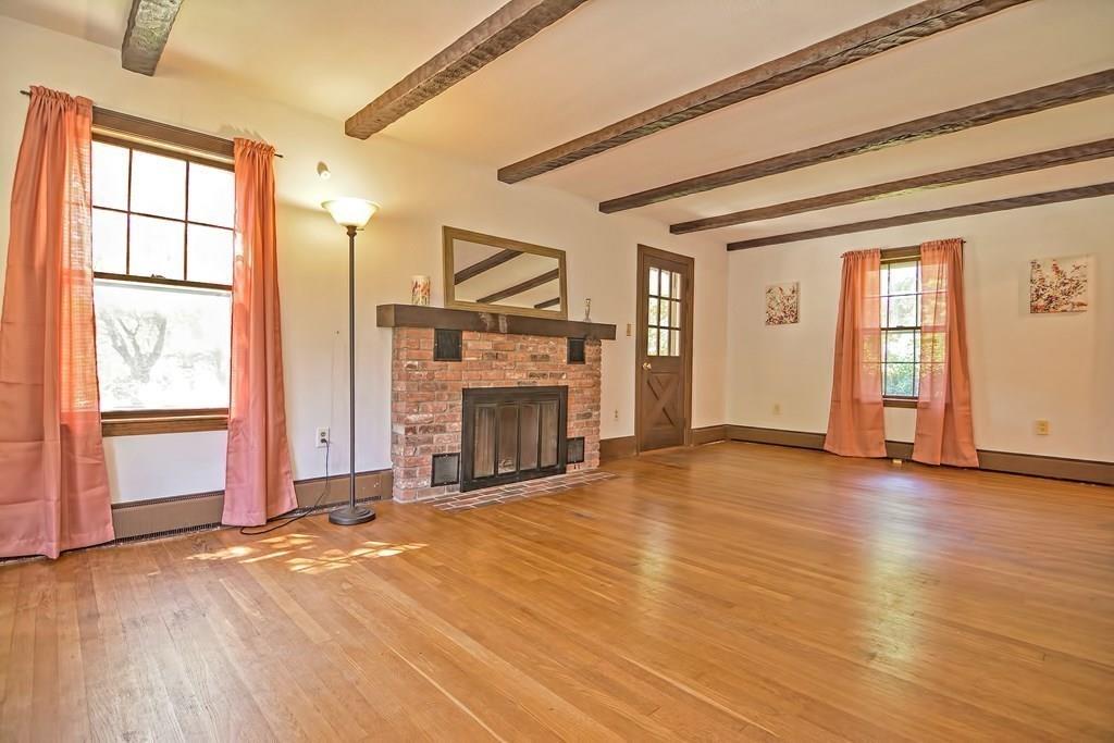 149 West Acton Road Stow, MA 01775 - Photo 7 of 42 an empty room with floor to ceiling window and fireplace