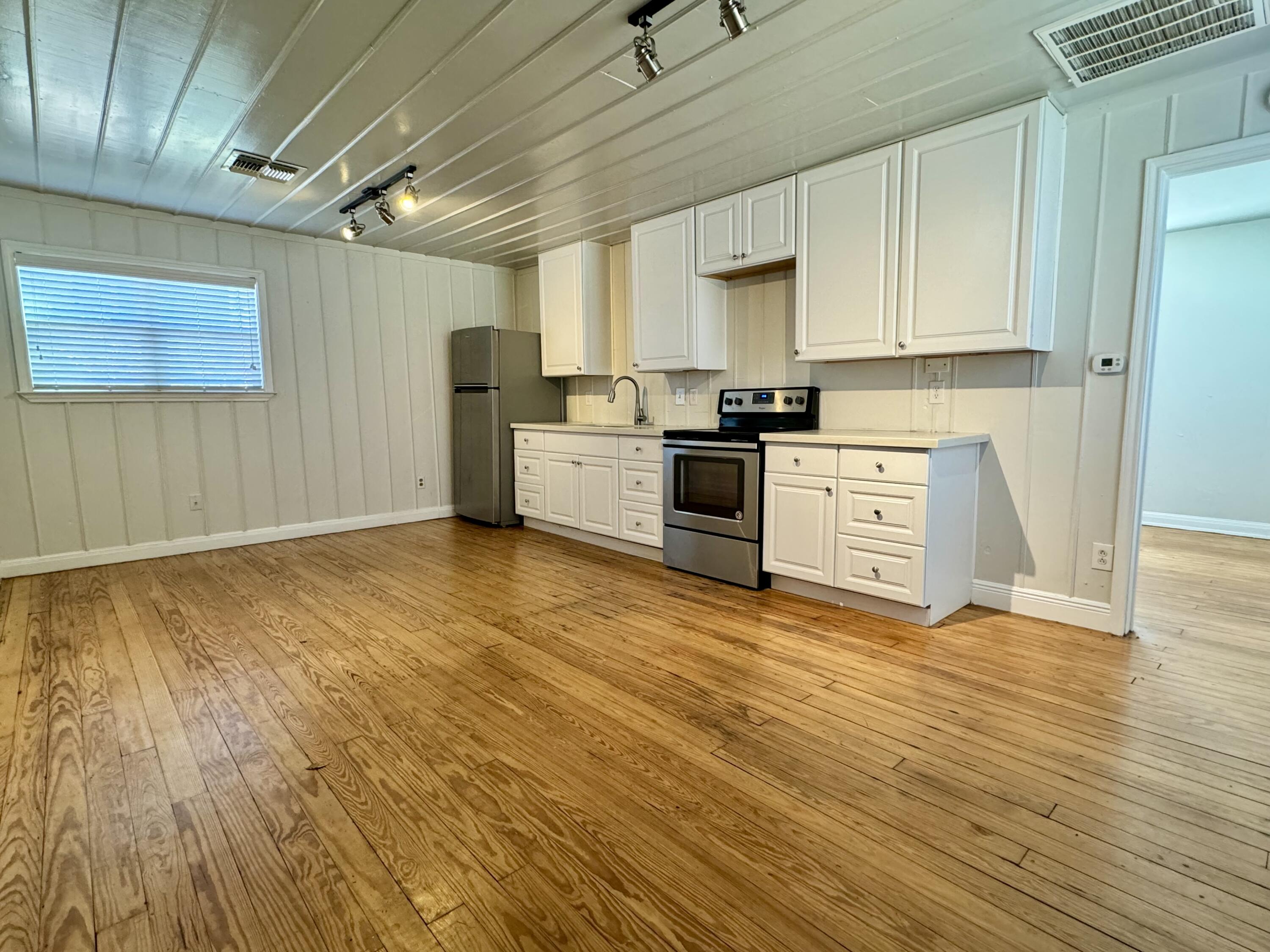 2107 14th Street, Unit B Lubbock, TX 79401 - Photo 1 of 6 a large kitchen with stainless steel appliances granite countertop a stove a sink and a refrigerator