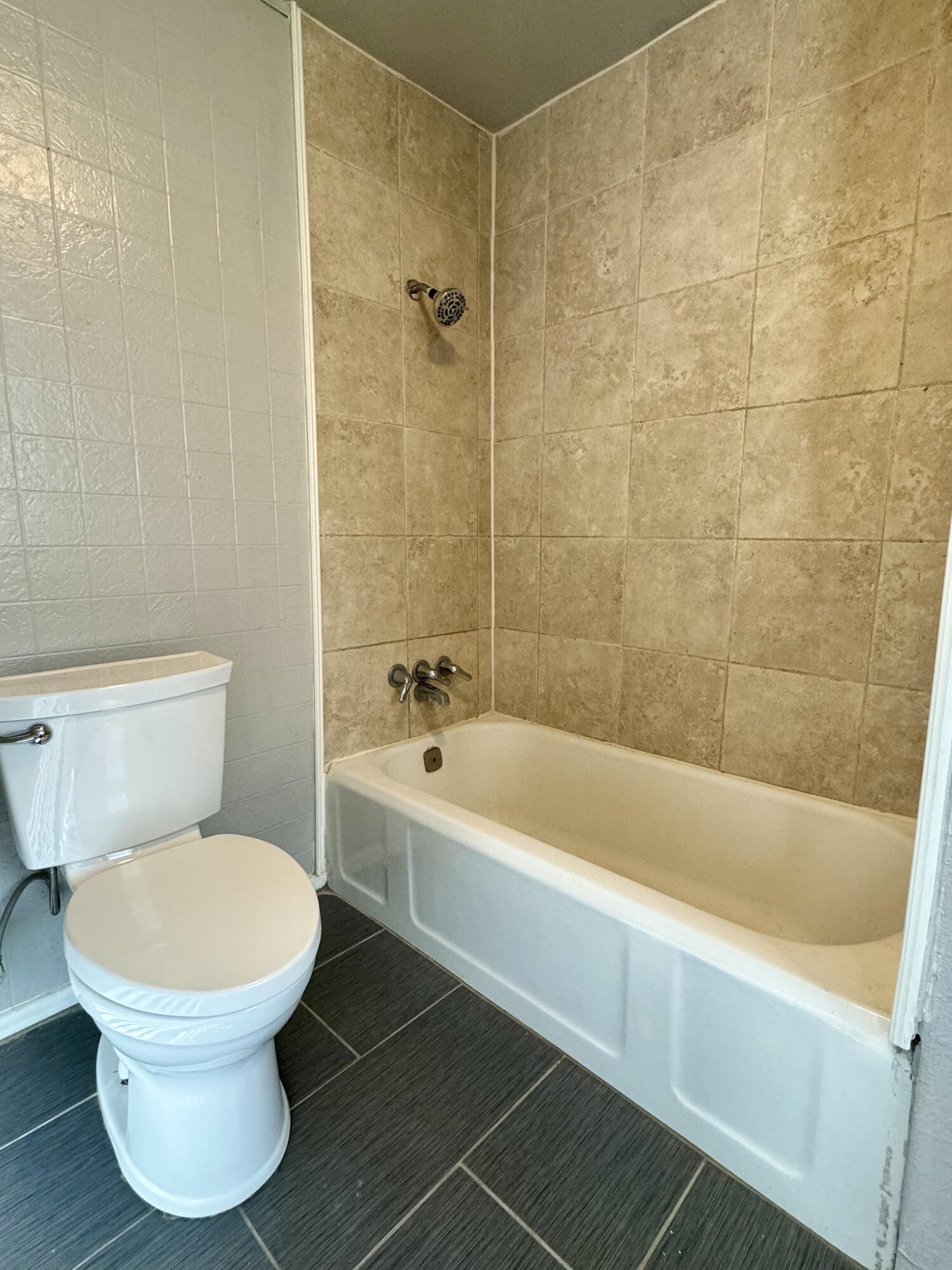 2107 14th Street, Unit B Lubbock, TX 79401 - Photo 5 of 6 a bathroom with a toilet and a bathtub
