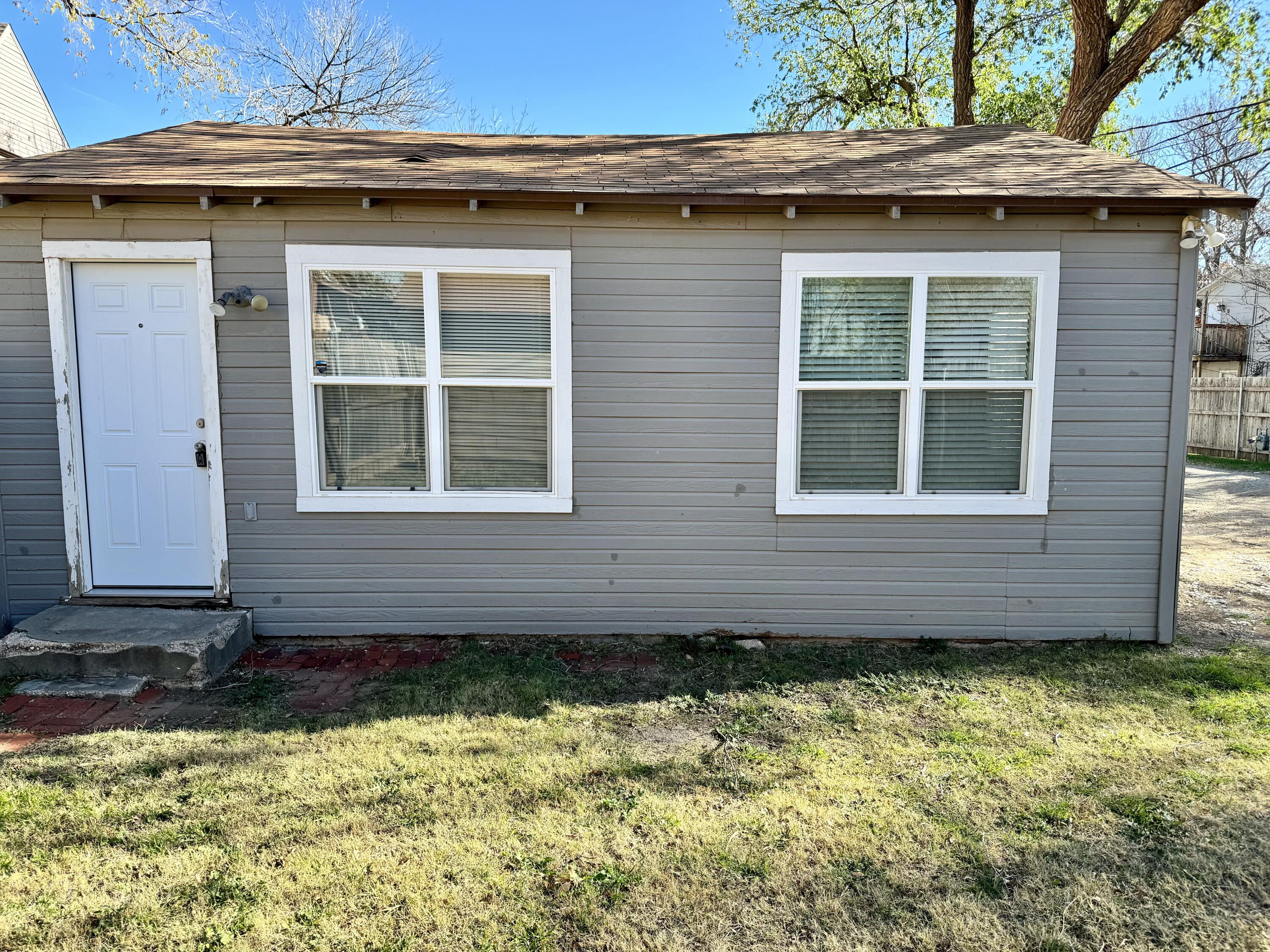 2107 14th Street, Unit B Lubbock, TX 79401 - Photo 6 of 6 a front view of a house with a yard