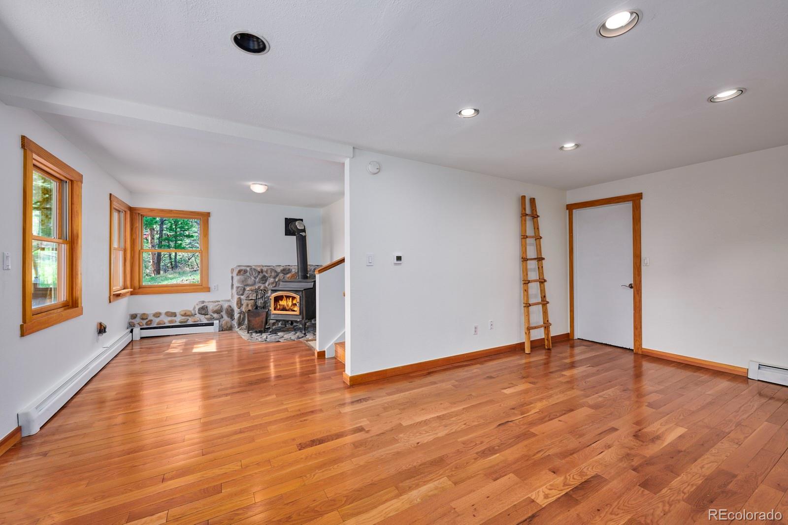 347 East Kelly Road Boulder, CO 80302 - Photo 17 of 29 a view of an empty room with a window and wooden floor