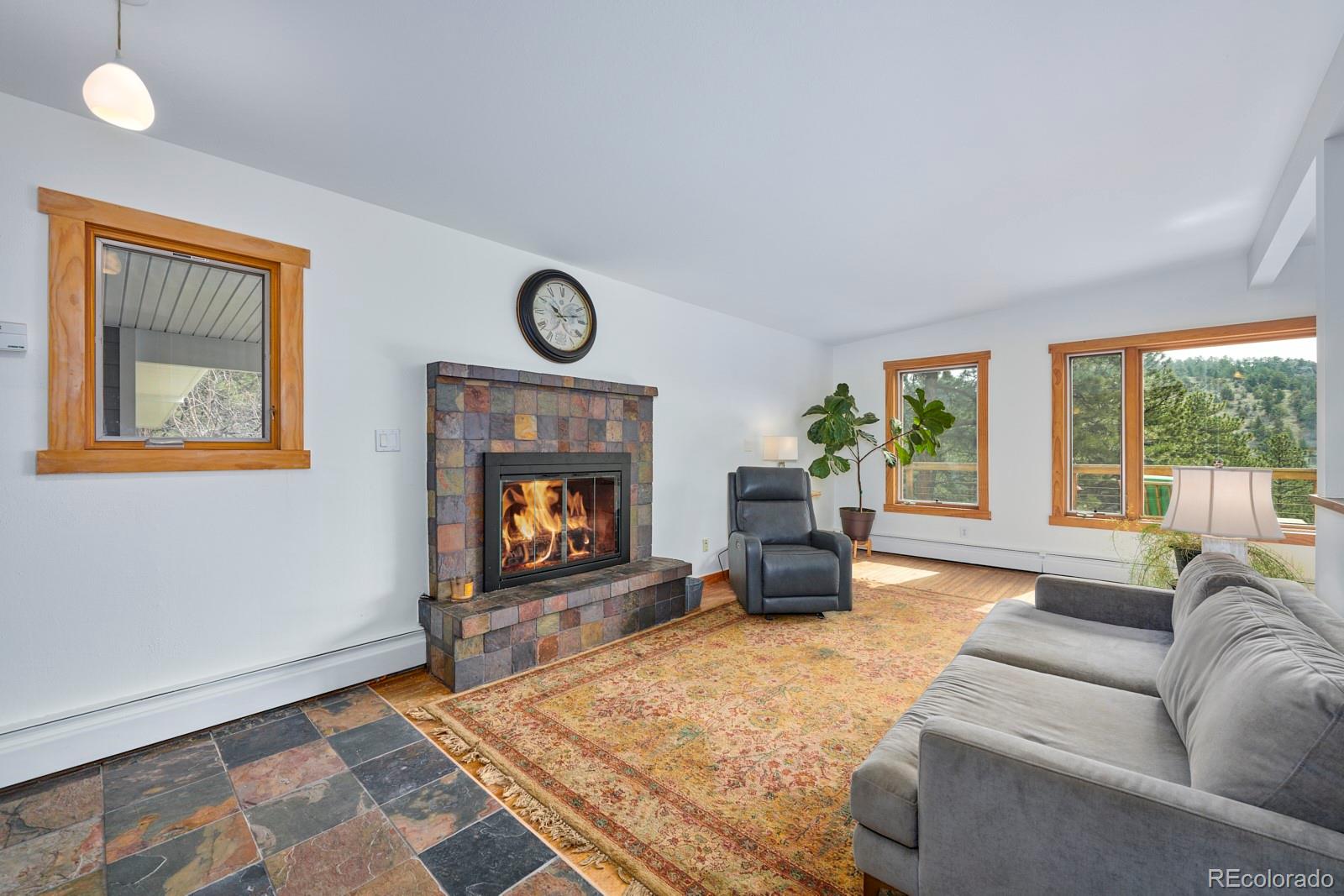347 East Kelly Road Boulder, CO 80302 - Photo 7 of 29 a living room with furniture a window and a fireplace