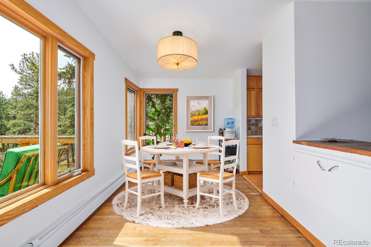 347 East Kelly Road Boulder, CO 80302 - Photo 8 of 29 a view of a dining room with furniture a chandelier and wooden floor