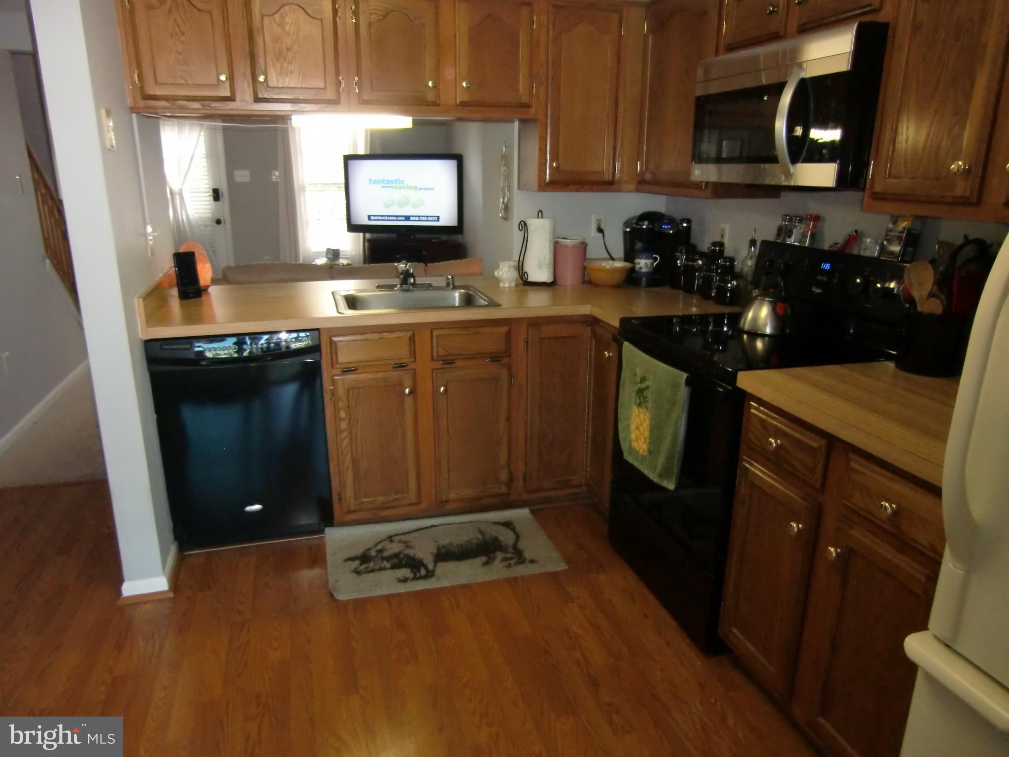 2236 Riding Crop Way Baltimore, MD 21244 - Photo 4 of 25 a kitchen with a sink stove and refrigerator