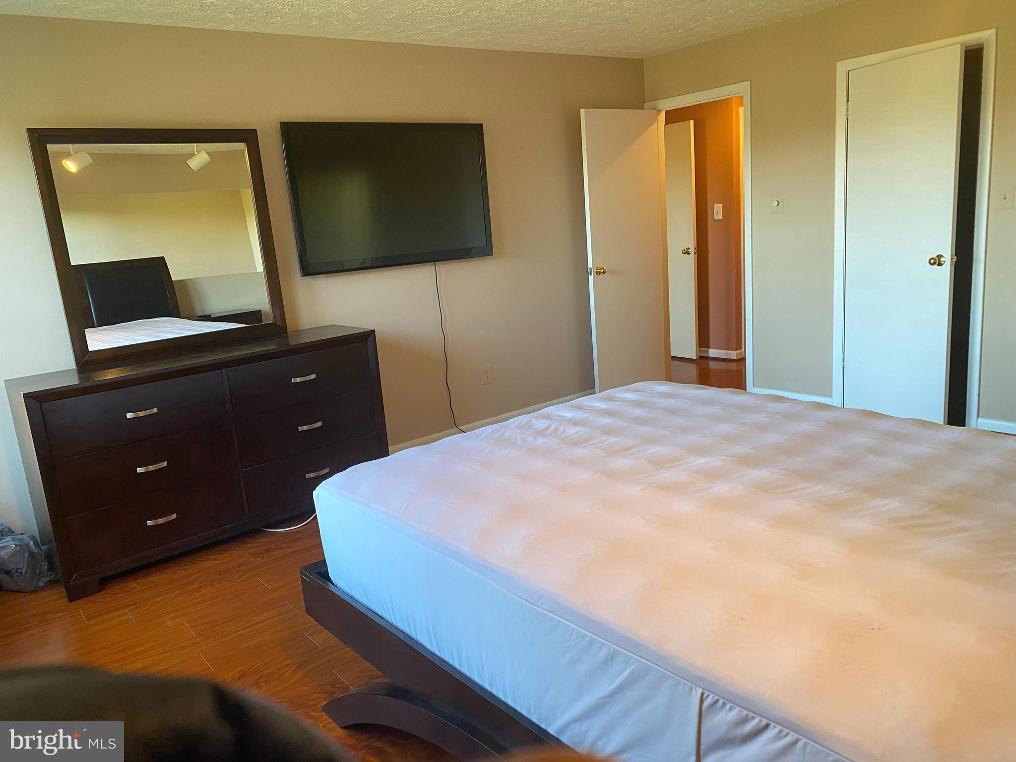 2109 B Woodbox Lane, Unit 2109B Baltimore, MD 21209 - Photo 14 of 26 a bedroom with a bed and a flat screen tv