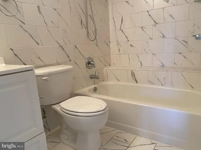 a bathroom with a toilet and a bathtub
