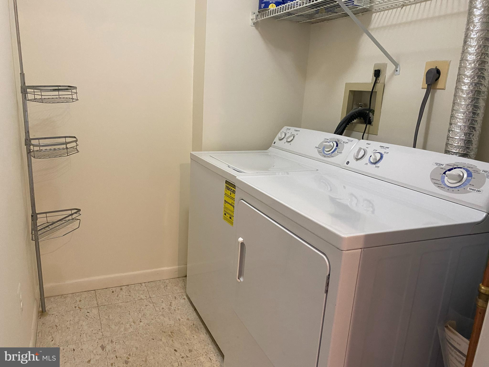 2109 B Woodbox Lane, Unit 2109B Baltimore, MD 21209 - Photo 22 of 26 a utility room with dryer and washer