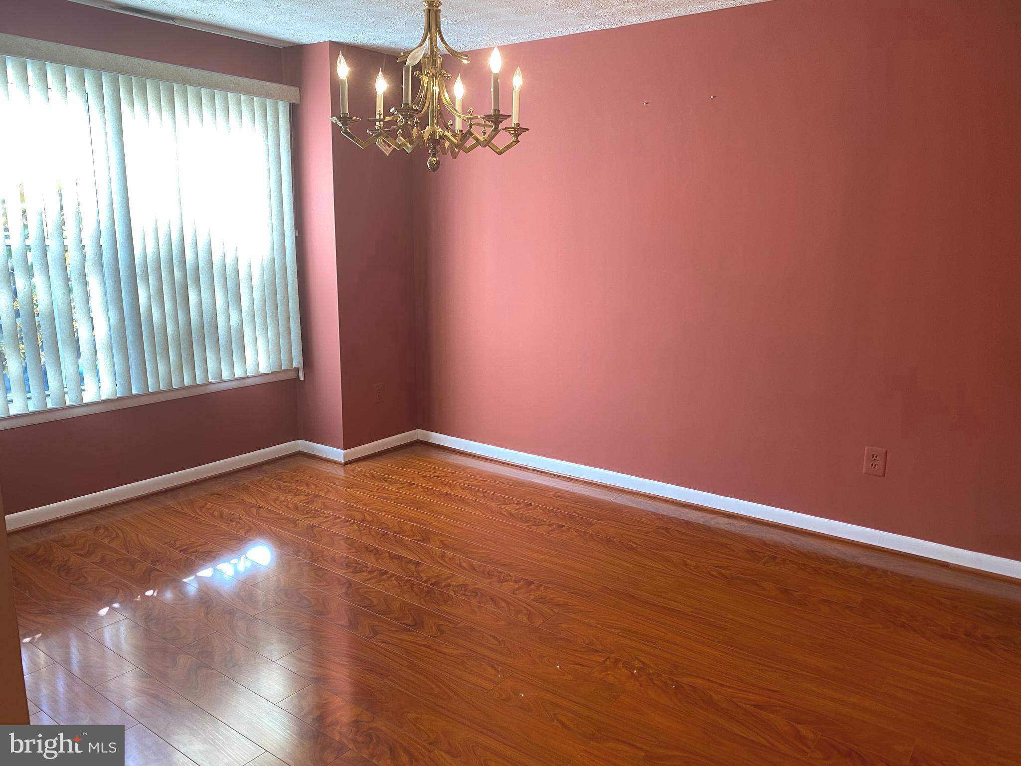 2109 B Woodbox Lane, Unit 2109B Baltimore, MD 21209 - Photo 8 of 26 a view of empty room with wooden floor and fan