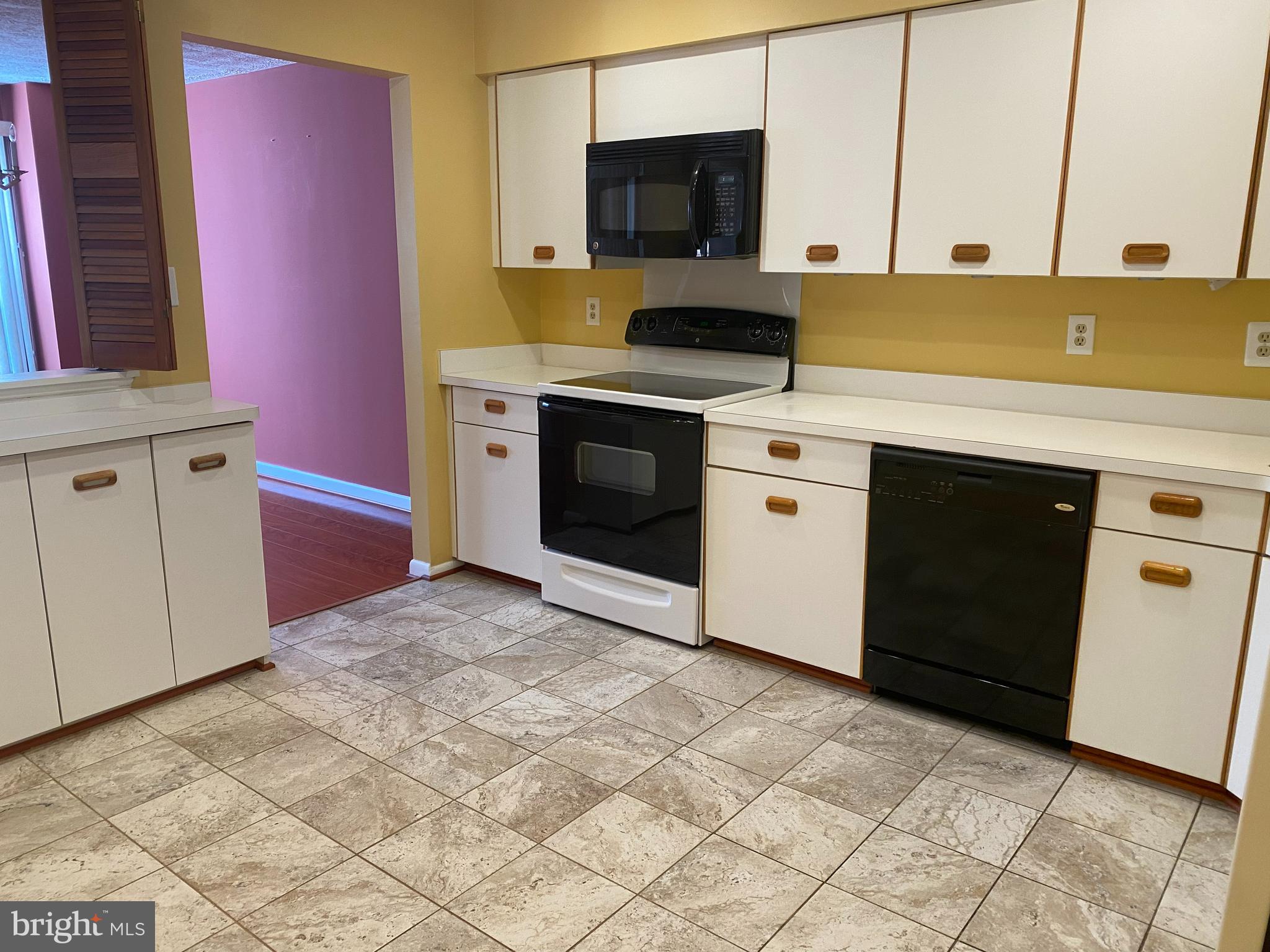 2109 B Woodbox Lane, Unit 2109B Baltimore, MD 21209 - Photo 10 of 26 a kitchen with stainless steel appliances granite countertop a stove a sink and a microwave