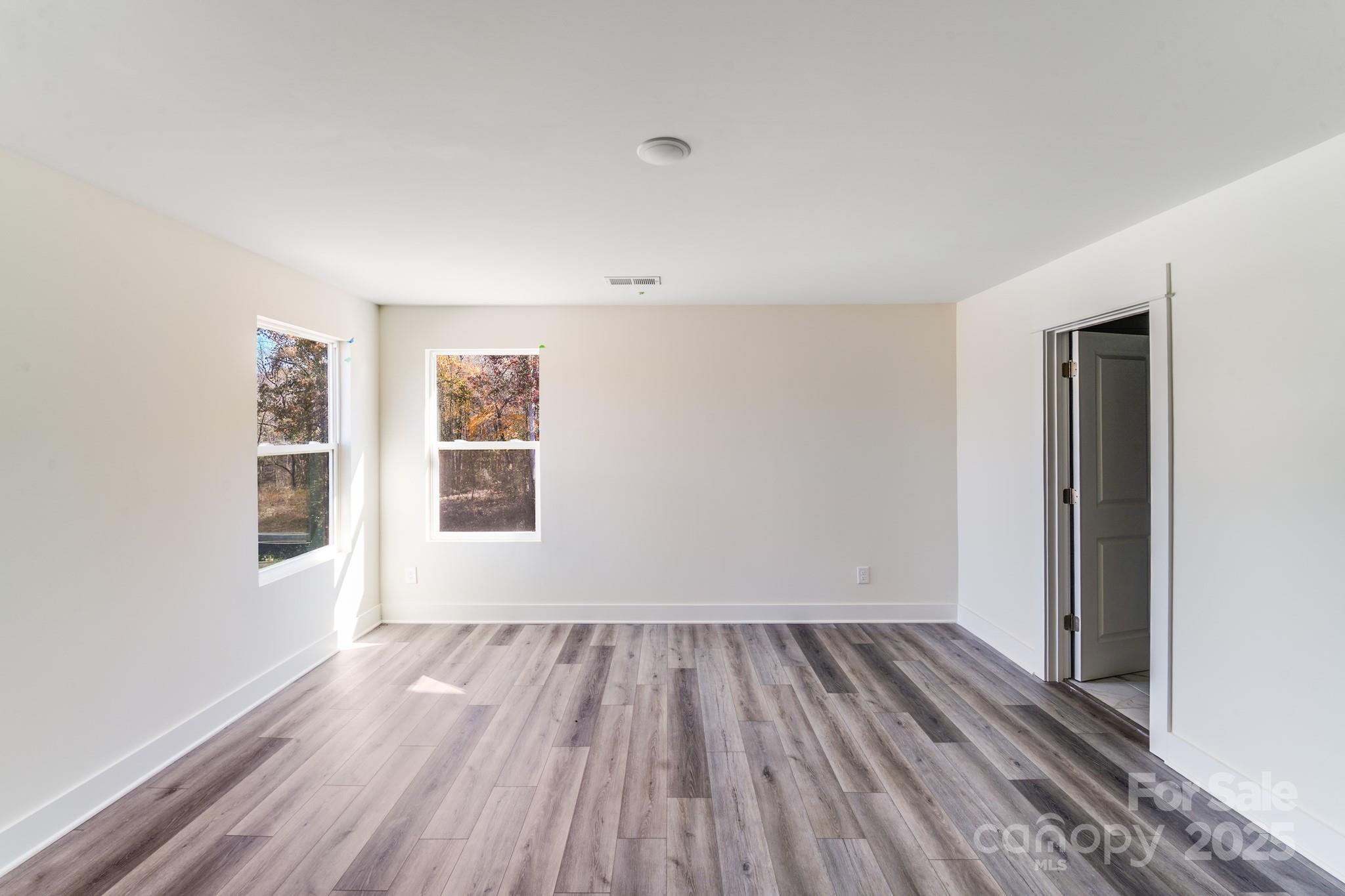 212 Sugar Hill Road Troutman, NC 28166 - Photo 5 of 47 a view of a room with wooden floor and window