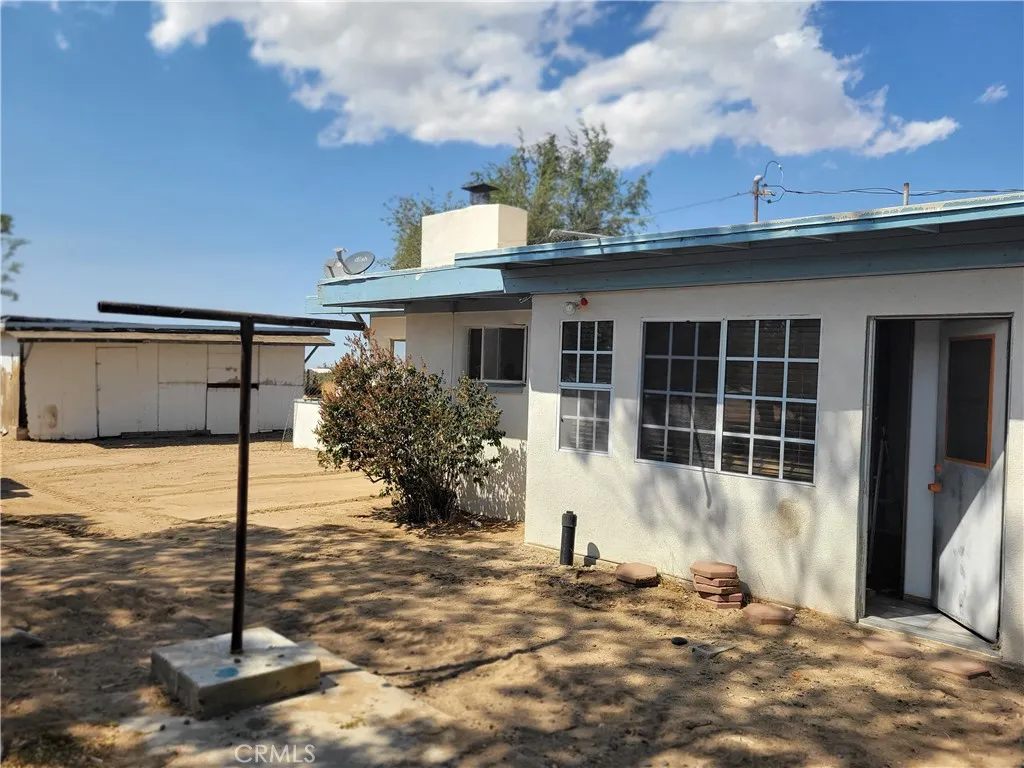 9116 Sierra Vista Road Phelan, CA 92371 - Photo 2 of 3 a front view of a house with a yard