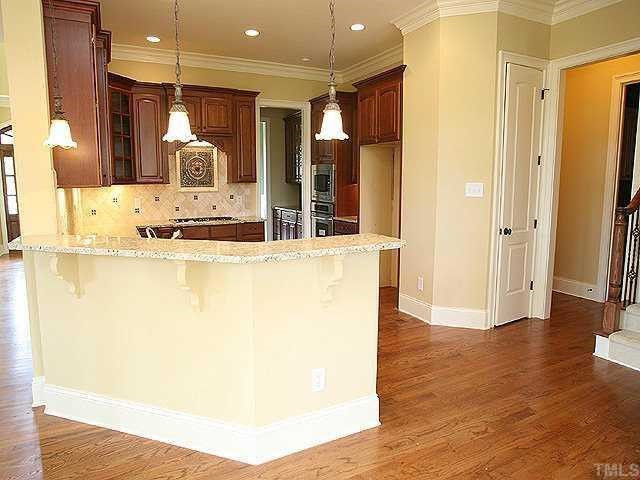 5300 Landguard Drive Raleigh, NC 27613 - Photo 4 of 12 Gorgeous gourmet kitchen w/granite, tile backsplash, ss appliances, gas range. Kitchen