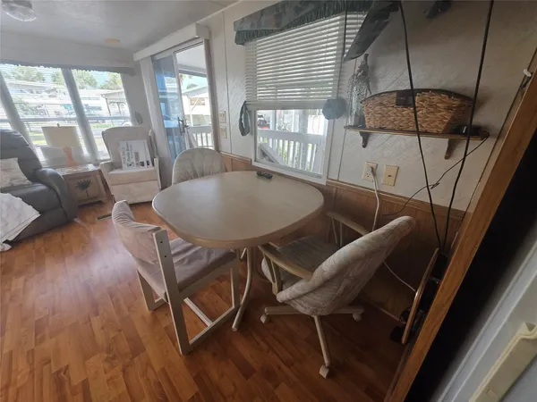 a dining room with furniture and wooden floor