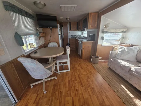 a dining room with furniture and wooden floor
