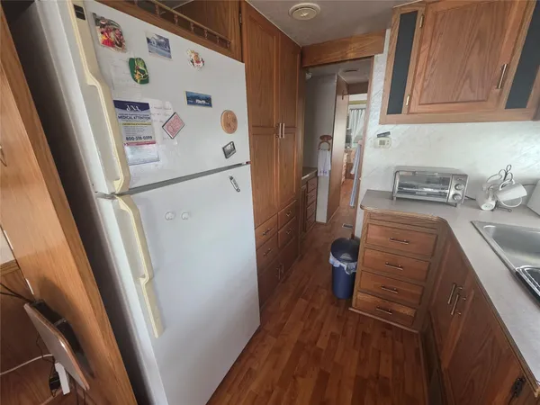 a white refrigerator freezer sitting inside of a kitchen