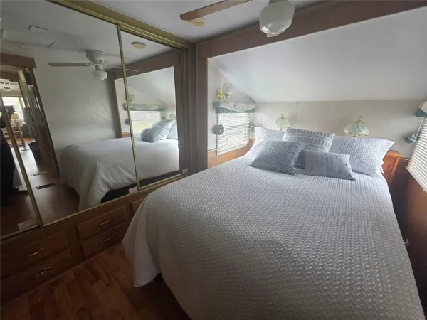 a bedroom with a bed and a mirror