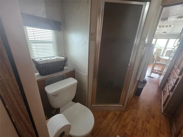 a white toilet sitting next to a window