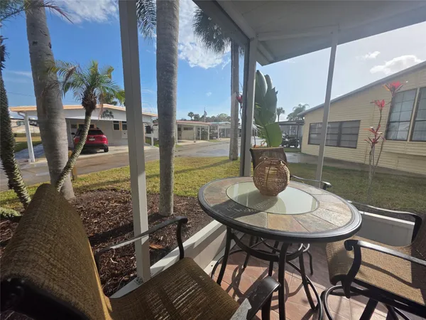 a dining room with furniture and a floor to ceiling window
