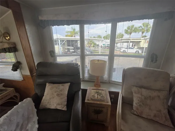 a living room with furniture and a floor to ceiling window