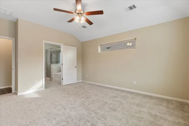 an empty room with closet and a chandelier fan