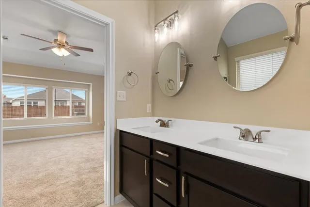 a bathroom with a double vanity sink and a mirror