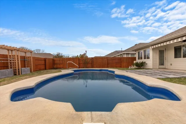 a view of swimming pool with a yard