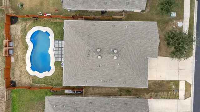 an aerial view of a house with a swimming pool
