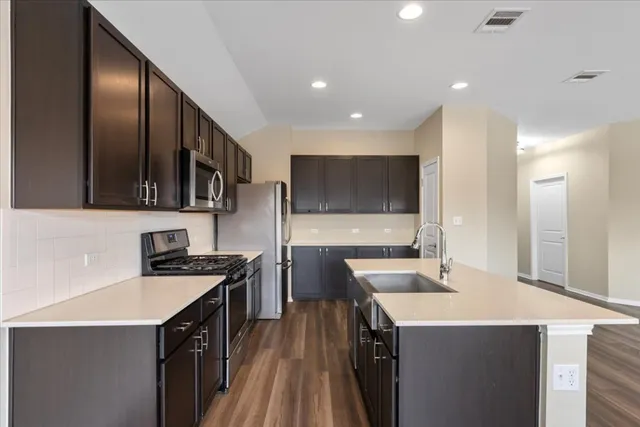a kitchen with a sink stove and refrigerator