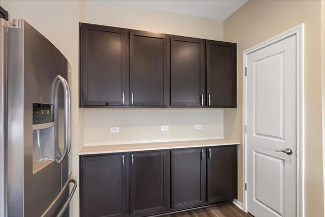 a kitchen with stainless steel appliances wooden cabinets and a refrigerator