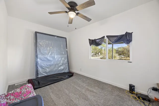 a bedroom with furniture and a ceiling fan