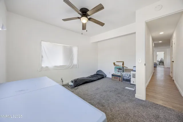 a view of a dry yard with wooden fence