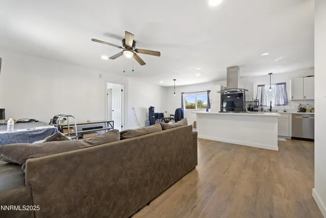 a living room with furniture and kitchen view