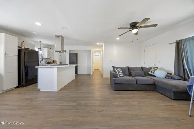 a kitchen with sink a refrigerator and wooden cabinets