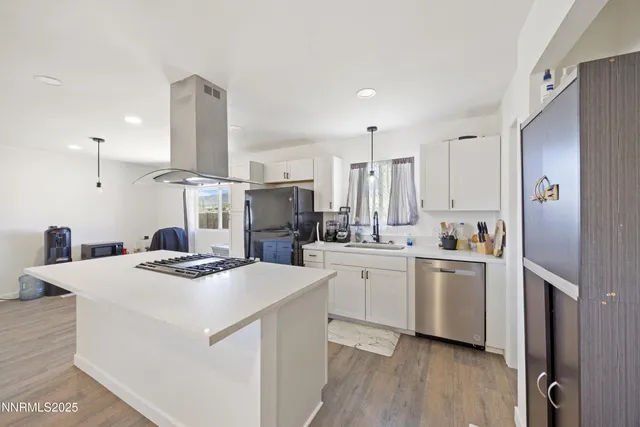 a kitchen with a stove a refrigerator and a sink