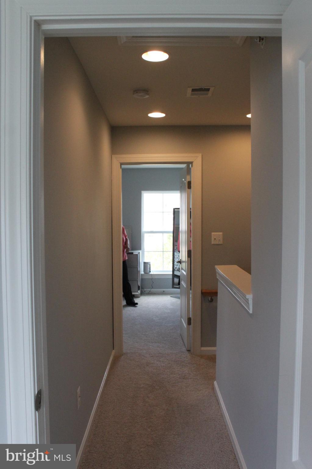 7452 Riding Meadow Way Manassas, VA 20111 - Photo 18 of 22 Inviting hallway with soft lighting.